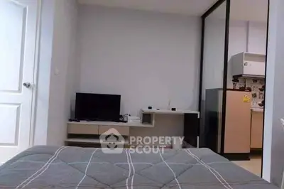 Cozy bedroom with modern decor and small TV setup