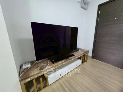 Modern living room with sleek TV setup on elegant marble console table.