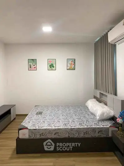 Modern bedroom with minimalist decor and comfortable bed in a stylish apartment.
