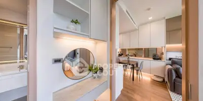 Modern open-plan apartment with stylish kitchen and cozy living area, featuring sleek design and natural light.