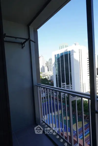 High-rise balcony with stunning cityscape view and modern railing design.