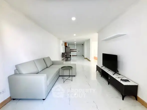 Spacious modern living room with sleek furniture and bright lighting