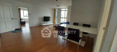 Spacious living room with modern dining area and natural light