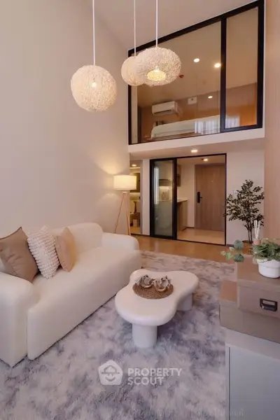 Modern duplex living room with stylish decor and mezzanine bedroom