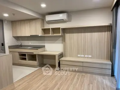 Modern kitchen with sleek cabinetry and integrated workspace in open layout