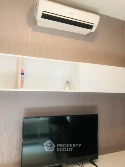 Modern living room with air conditioning and sleek TV setup