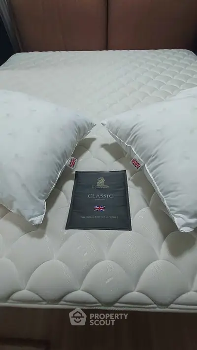 Luxurious bedroom setup with plush mattress and pillows, ideal for comfort and relaxation.