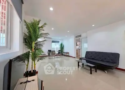 Spacious modern living room with sleek furniture and bright lighting