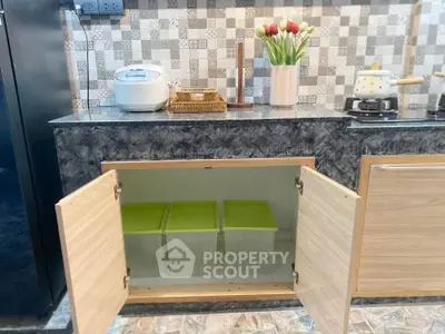 Modern kitchen with stylish backsplash and open cabinet storage