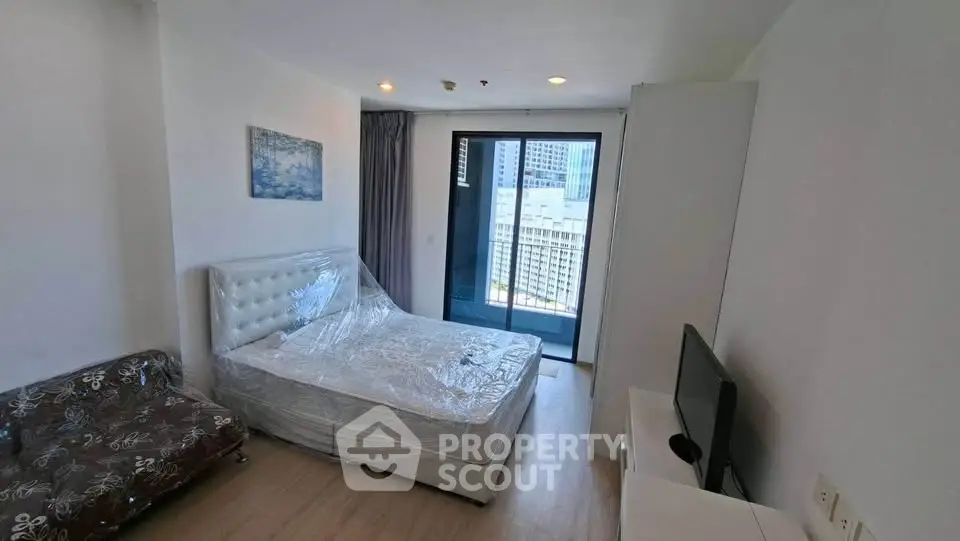 Modern bedroom with balcony view in high-rise apartment