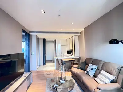 Modern living room with stylish decor and open kitchen layout in a contemporary apartment.