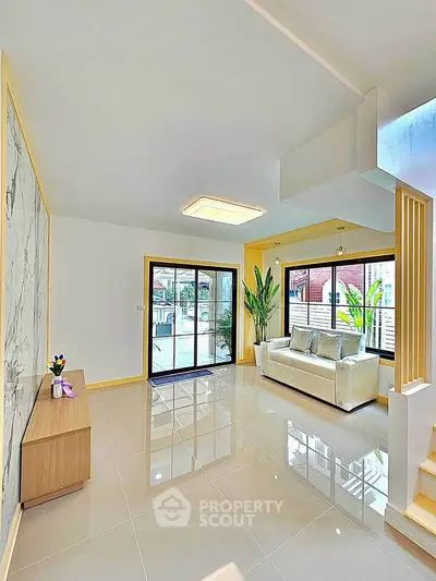 Spacious modern living room with large windows and elegant decor
