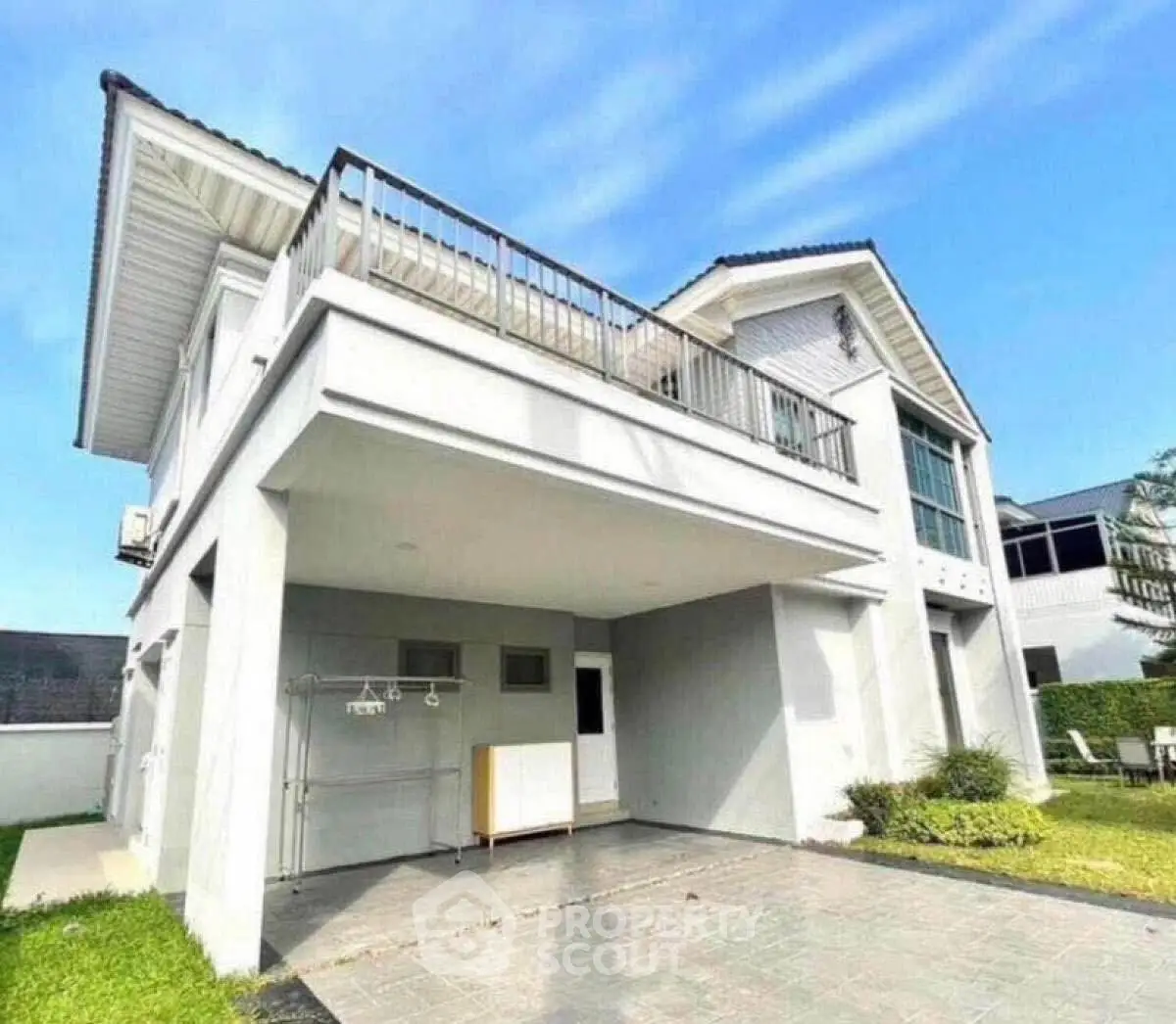 Modern two-story house with spacious balcony and driveway