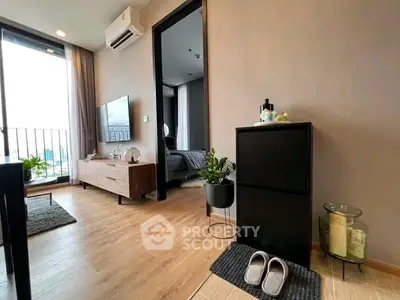 Modern apartment interior with stylish decor and open layout, featuring a cozy living area and bedroom view.