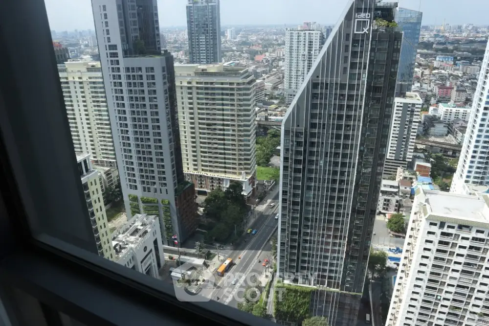 Stunning cityscape view from high-rise apartment window showcasing modern urban living.