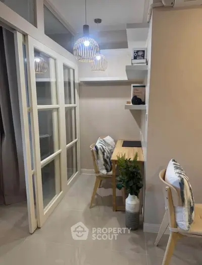 Modern study nook with stylish lighting and cozy seating in a compact space