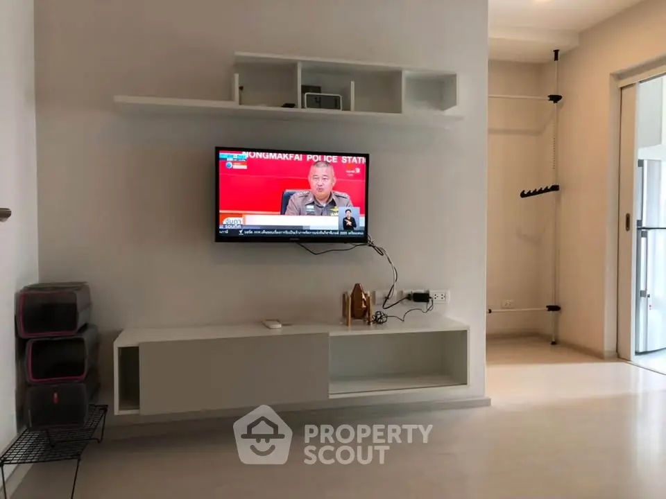 Modern living room with wall-mounted TV and minimalist decor
