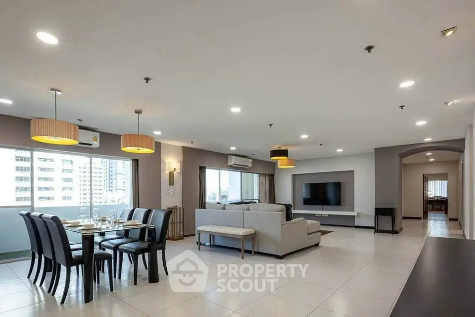 Spacious modern living room with dining area and city view