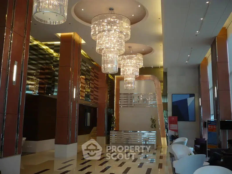 Luxurious lobby with grand chandeliers and modern design elements