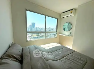 Bright bedroom with city view and air conditioning in modern apartment