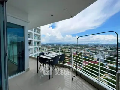 Spacious balcony with stunning city view, perfect for outdoor dining and relaxation.