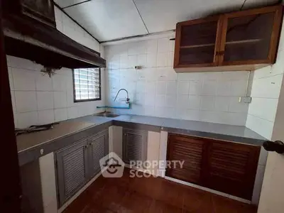 Cozy kitchen with ample storage and natural light, perfect for culinary enthusiasts.