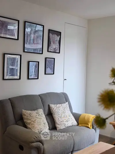 Cozy living room with stylish wall art and comfortable grey sofa
