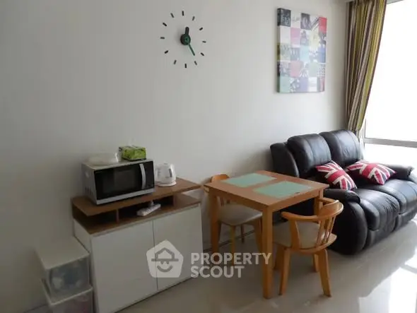 Cozy living room with modern decor and compact dining area