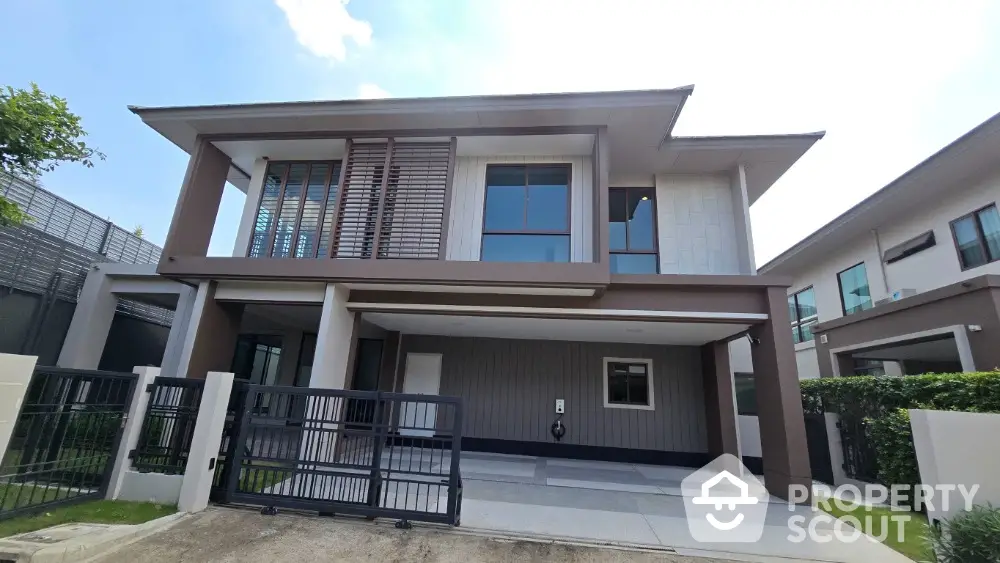 Modern two-story house with sleek design and spacious driveway in a serene neighborhood.