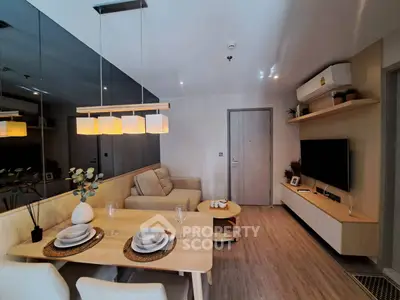 Modern living room with stylish decor and cozy dining area in open layout apartment.