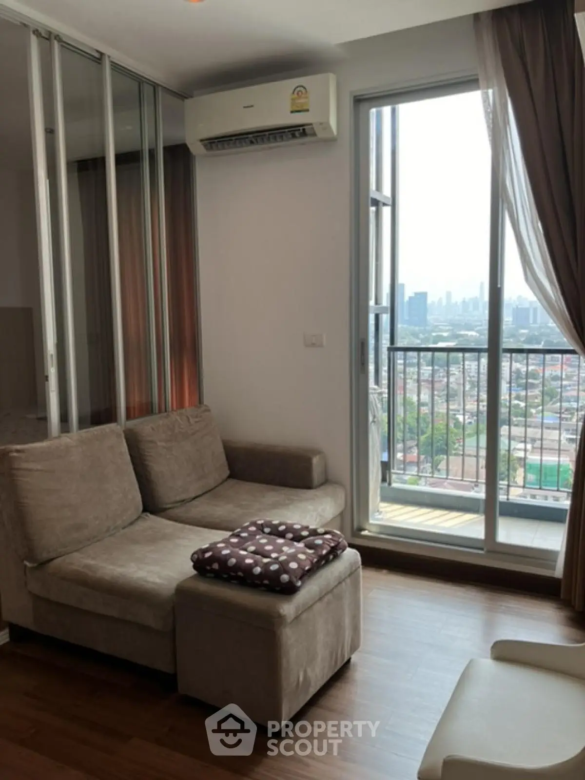 Modern living room with city view and cozy seating area