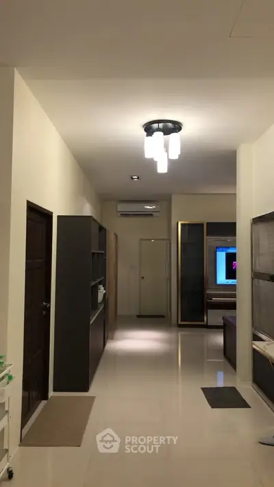 Spacious hallway with modern lighting and sleek storage solutions in a contemporary apartment.