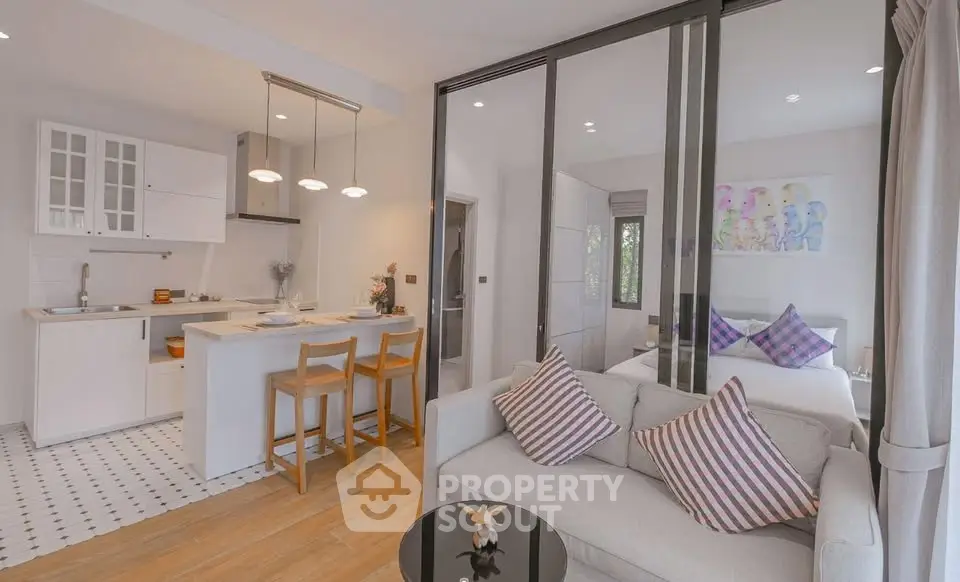 Modern open-plan living room and kitchen with stylish decor and natural light.
