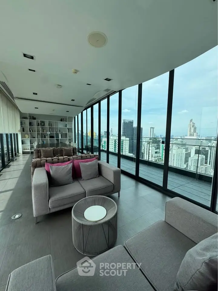 Luxurious high-rise living room with panoramic city views and modern furnishings.