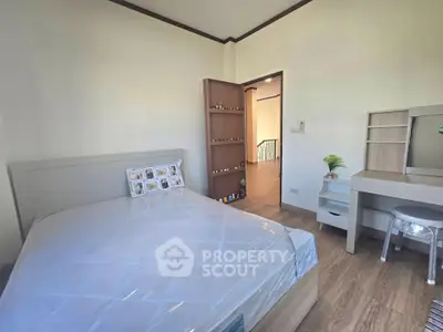 Cozy bedroom with modern furnishings and natural light, perfect for relaxation.