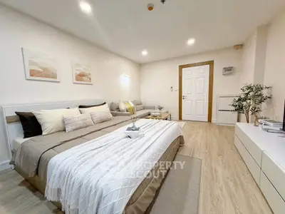 Spacious modern bedroom with cozy decor and elegant furnishings