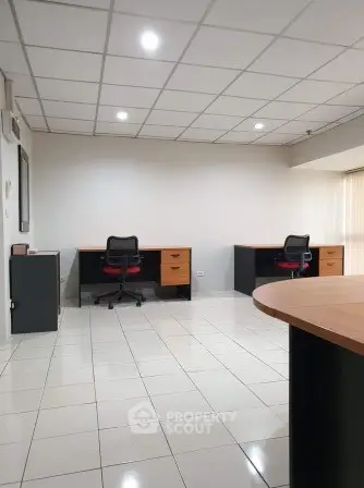Spacious office space with modern desks and chairs, ideal for a productive work environment.
