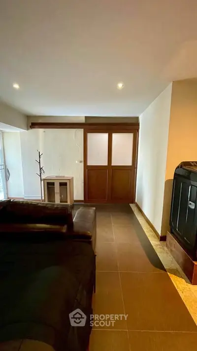 Spacious living room with modern decor and ample natural light