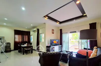 Spacious living room with modern decor and large windows for natural light.