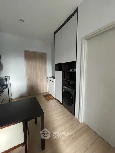 Modern kitchen with sleek cabinetry and integrated washing machine