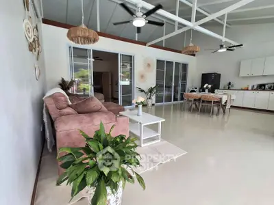 Spacious open-plan living room with modern decor and natural light