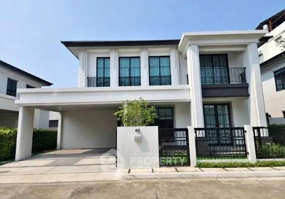 Elegant modern two-story house with spacious driveway and sleek black accents.