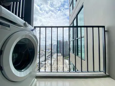Modern balcony with city view and washing machine, perfect urban living space.