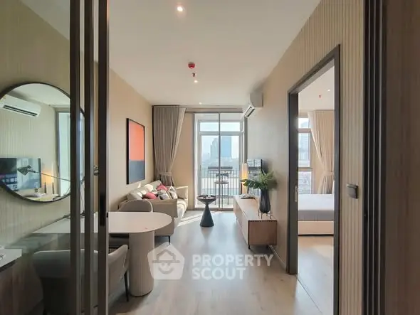 Modern apartment interior with open living room and city view balcony.