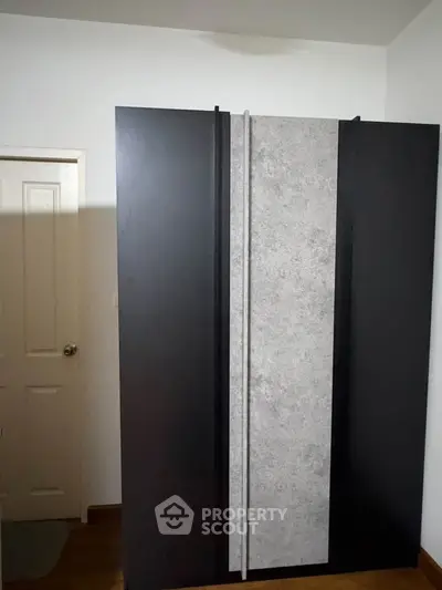 Modern wardrobe in a stylish bedroom with sleek design and ample storage space.