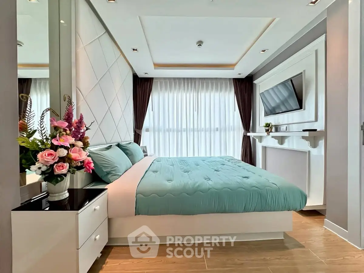 Luxurious bedroom with modern decor and large window for natural light.