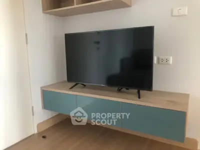 Modern living room with sleek wall-mounted TV and stylish cabinetry