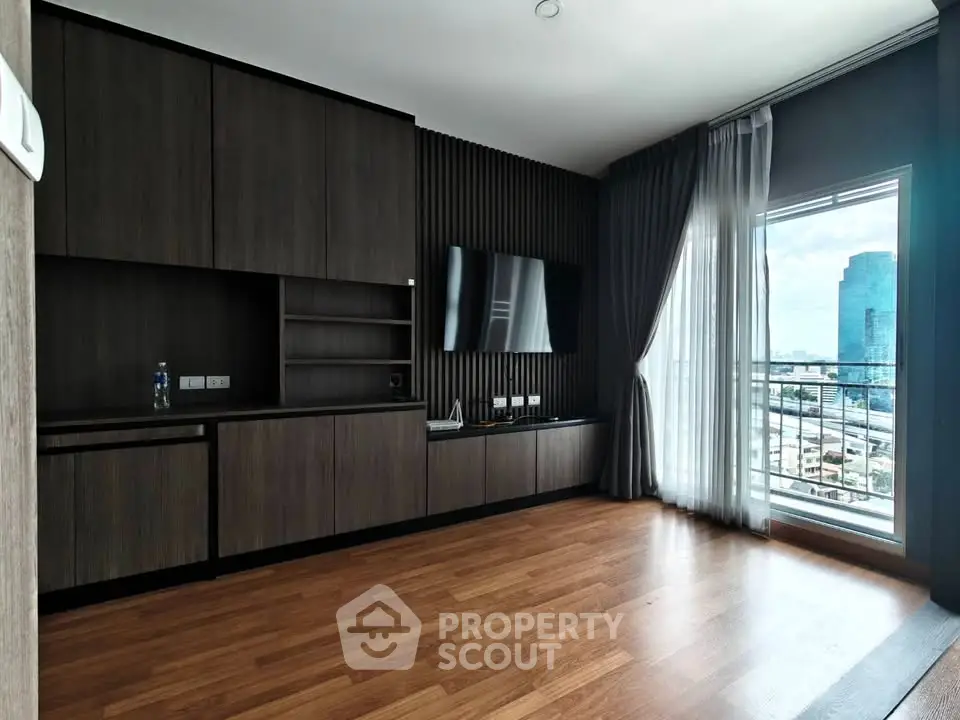 Modern living room with wooden flooring and city view balcony