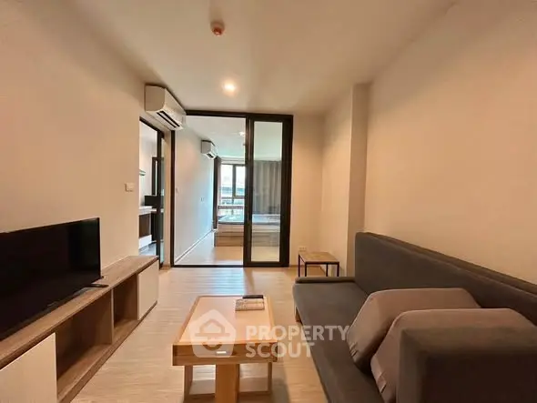 Modern living room with sleek furniture and natural light, perfect for relaxation and entertainment.