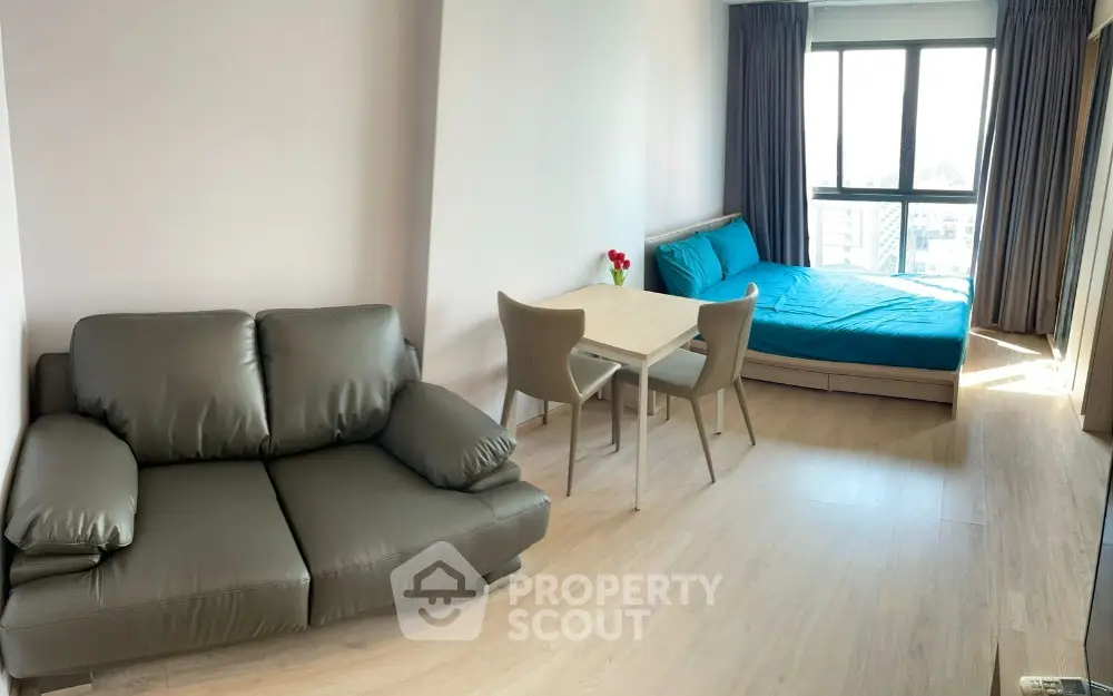 Modern studio apartment with cozy living area and bright natural light